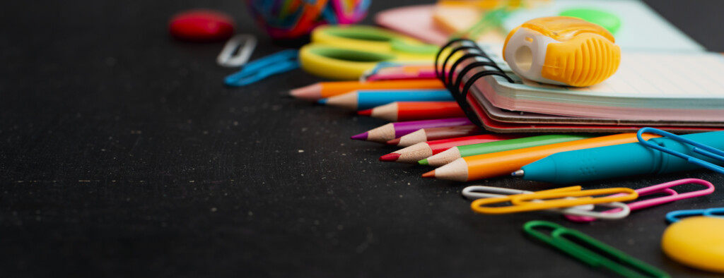 School Supplies Top View On The Background Of The Chalkboard.